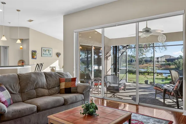 a living room with furniture wooden floor and a table