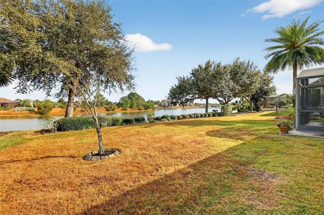 a view of a lake with houses in the back