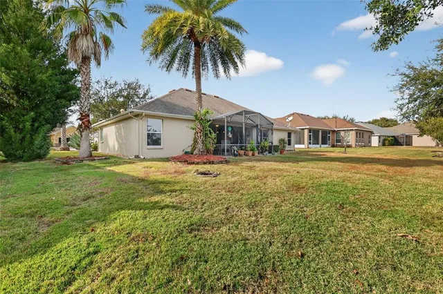 an aerial view of residential houses with outdoor space and lake view