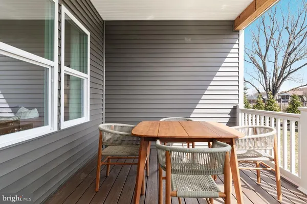 a view of a patio with a table and chairs under an umbrella with wooden floor