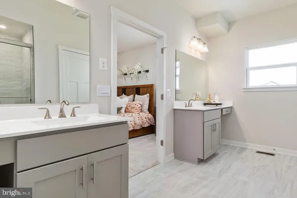 a en suite bathroom with a double vanity sink and mirror