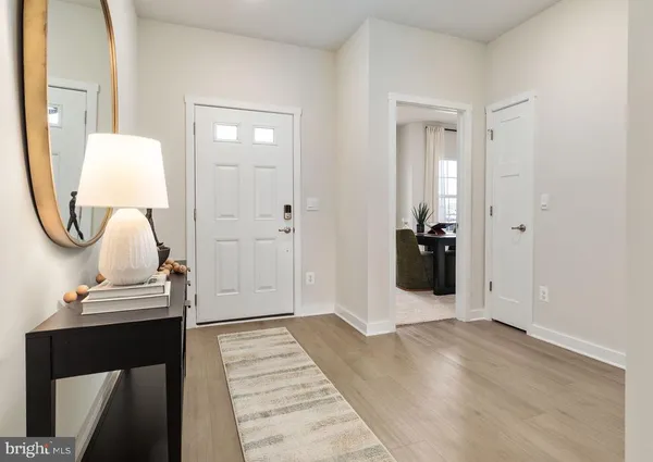 a view of a livingroom with wooden floor and workspace
