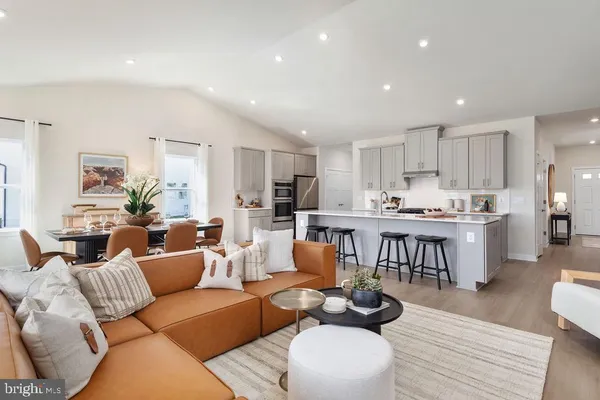 a living room with furniture and kitchen view