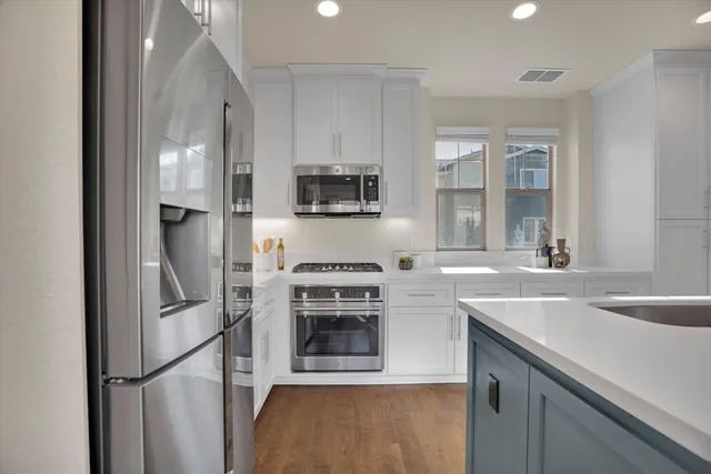 a kitchen with a sink and stainless steel appliances