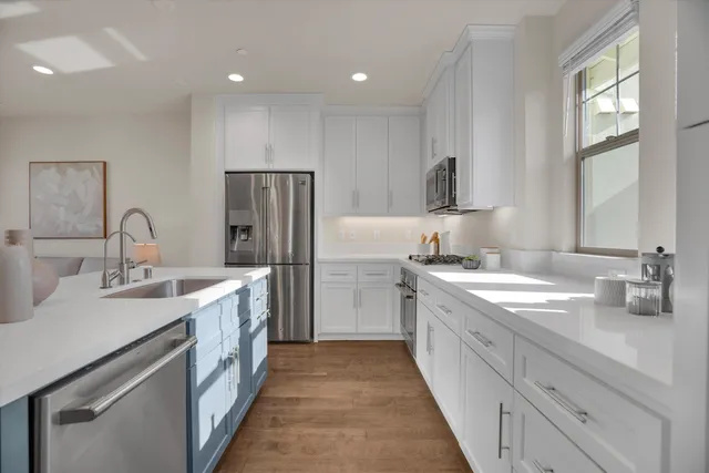 a kitchen with a sink stove and refrigerator