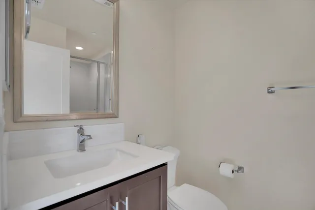 a bathroom with a sink toilet and vanity