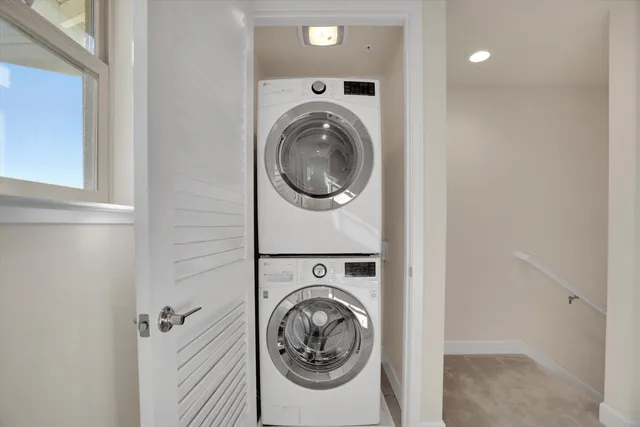 a utility room with sink dryer and washer