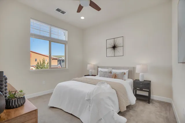 a bedroom with a bed and a window