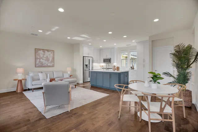 a living room with furniture dining table and wooden floor