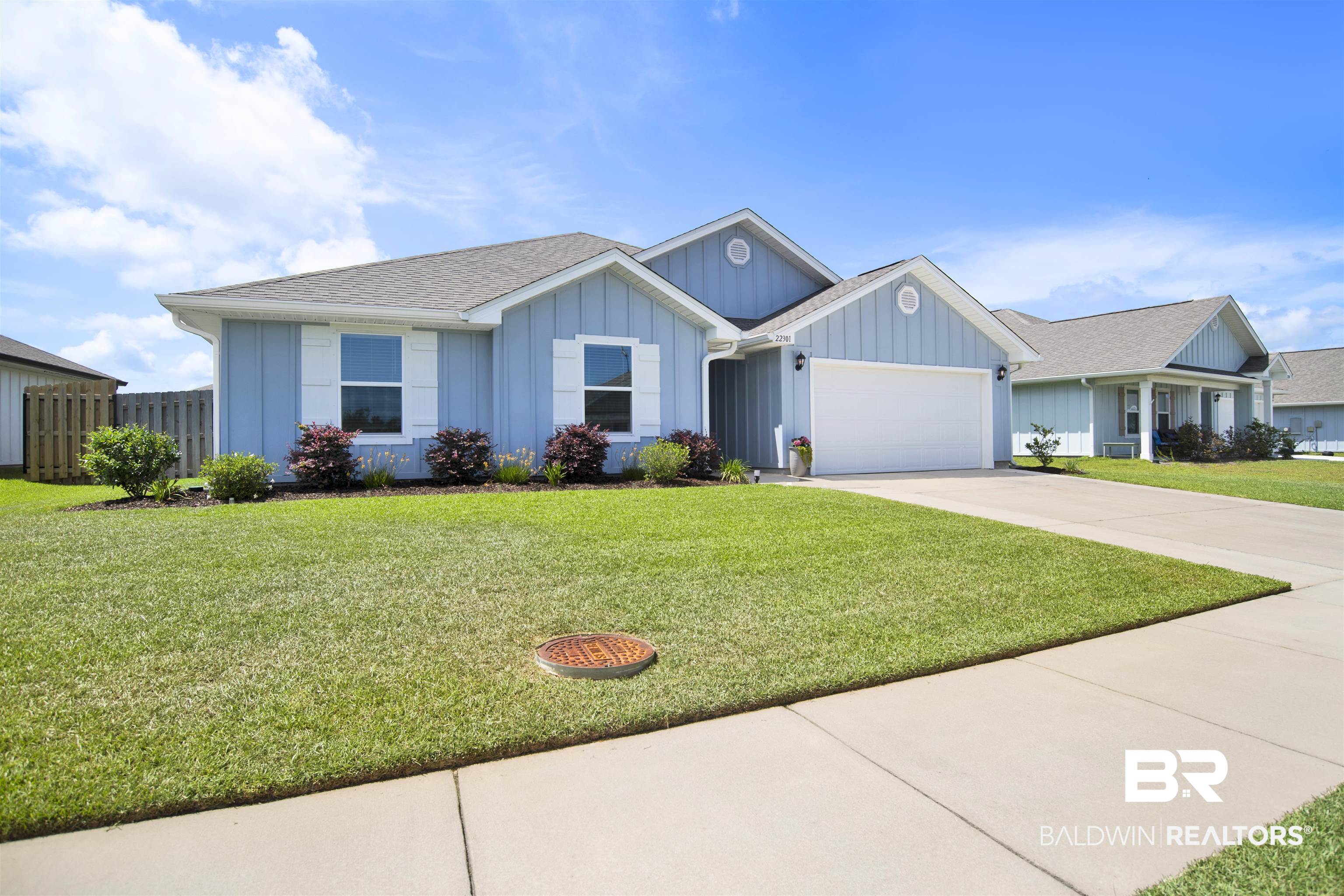 22301 Early Dawn Circle Foley, AL 36535 - Photo 2 of 45 Light blue exterior siding with white trim and shutters