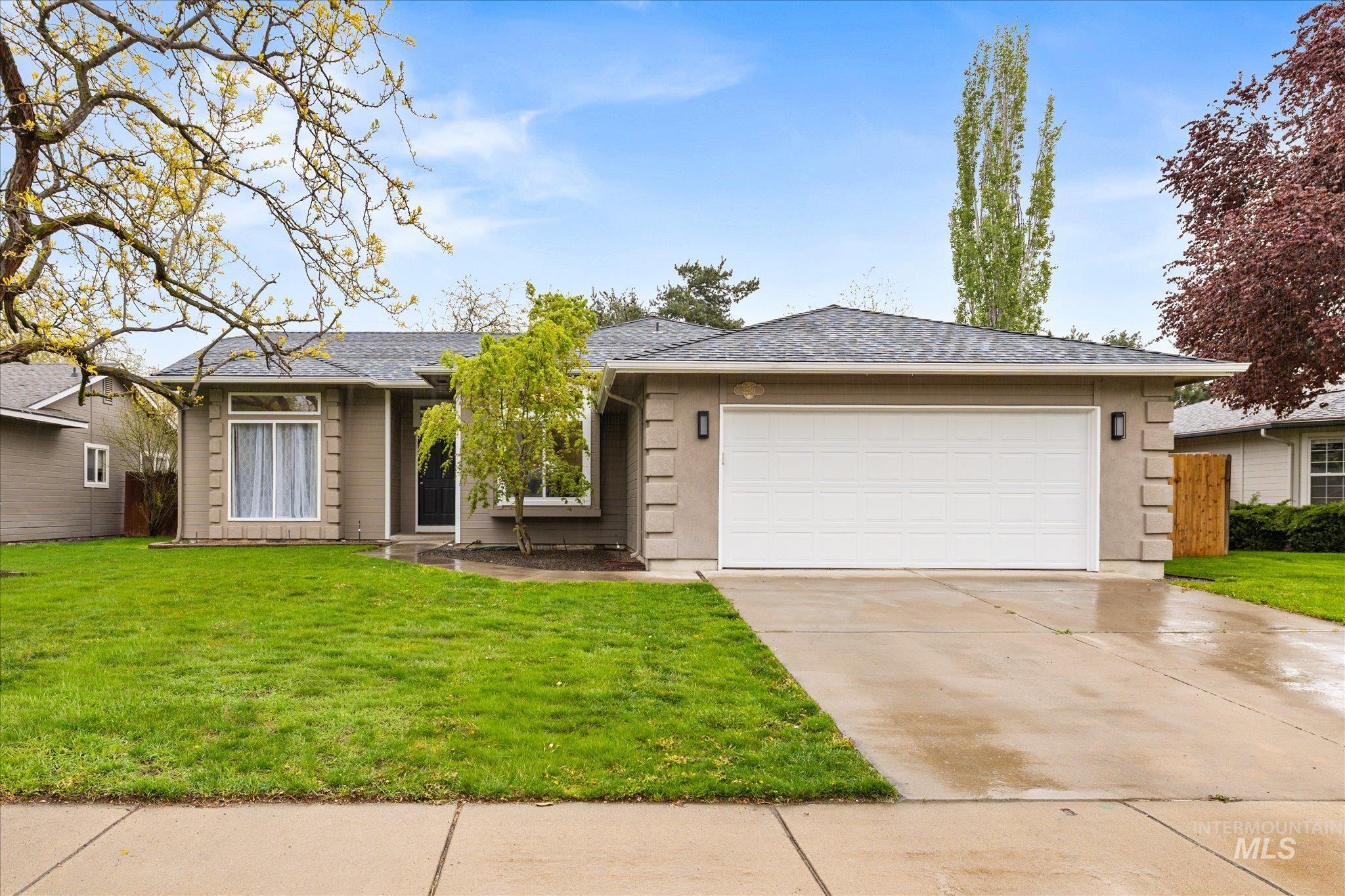 2250 North Amethyst Avenue Meridian, ID 83646 - Photo 2 of 50 Single story home featuring a front yard, an attached garage, concrete driveway, and roof with shingles