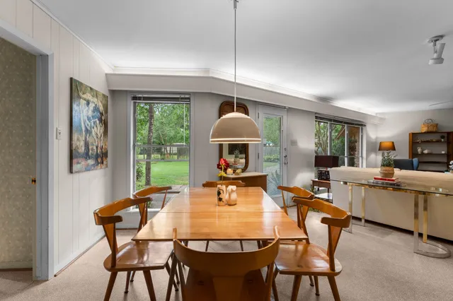 a view of a dining room with furniture window and outside view