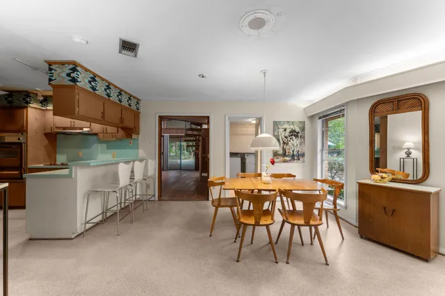 a dining room with furniture and window