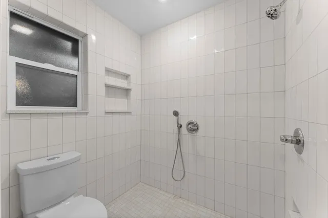 a bathroom with a toilet sink and shower