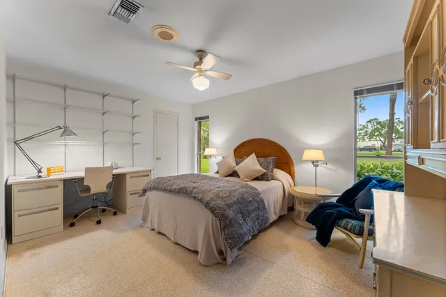 a bedroom with bed and window