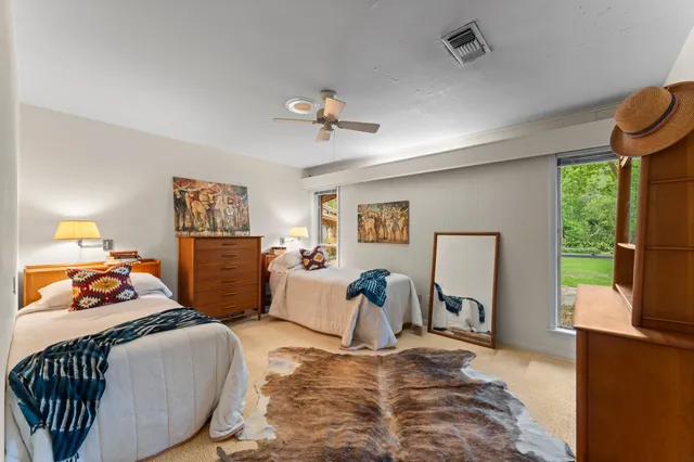 a bedroom with furniture and a window
