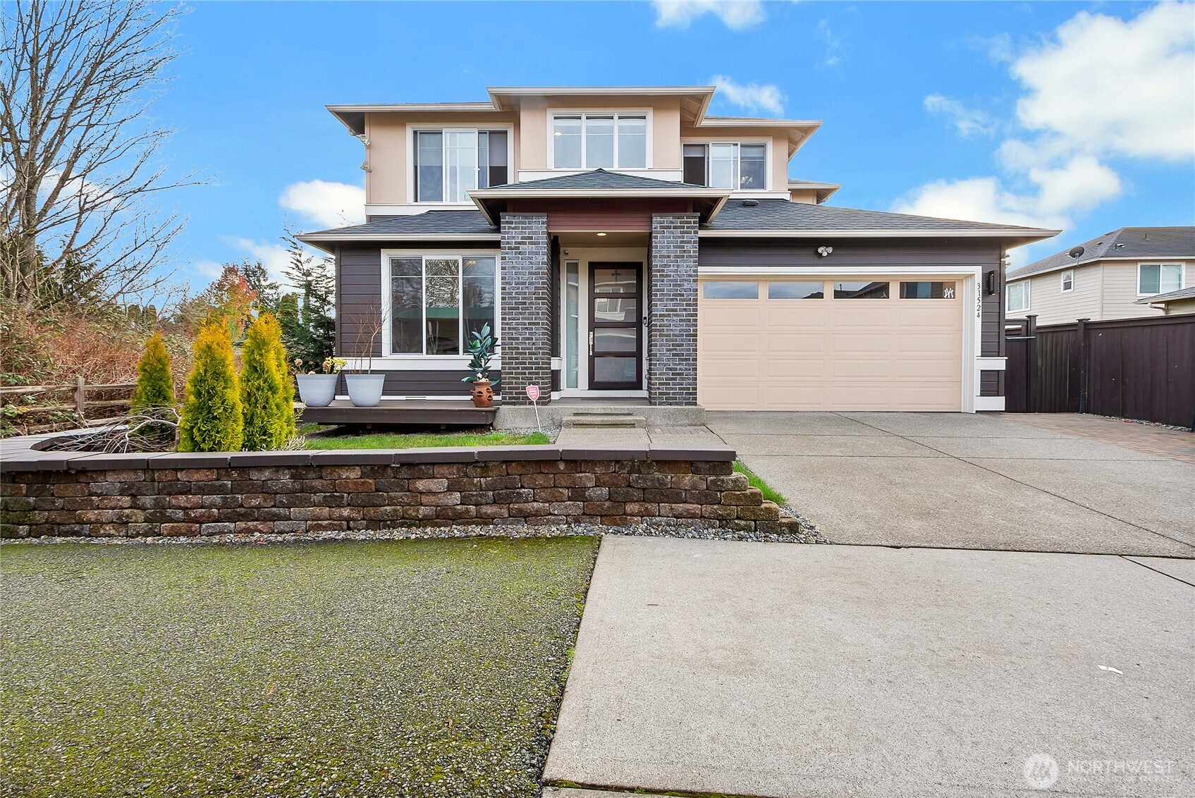 a front view of a house with a garden and swimming pool