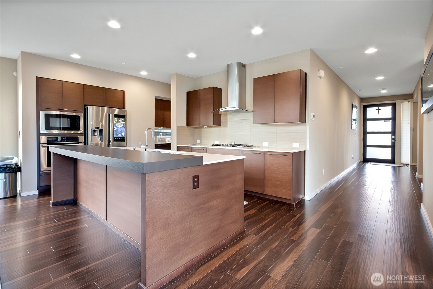 31524 11th Place Southwest Federal Way, WA 98023 - Photo 6 of 40 a kitchen with kitchen island granite countertop wooden floors and stainless steel appliances