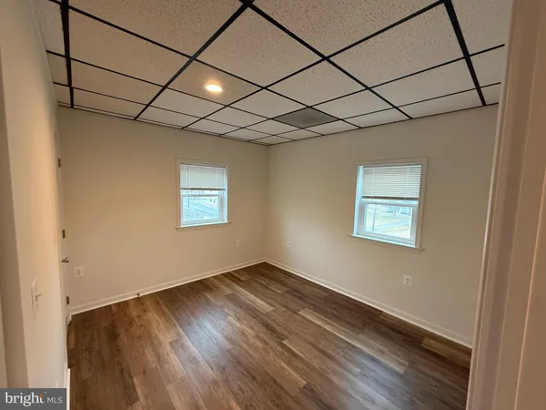 a view of a room with wooden floor and window