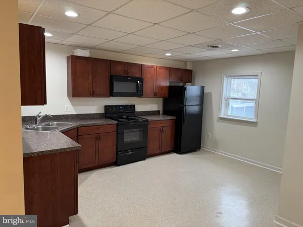 a kitchen with stainless steel appliances granite countertop a refrigerator stove and sink