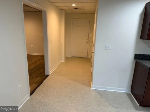 a view of hallway with stairs and wooden floor