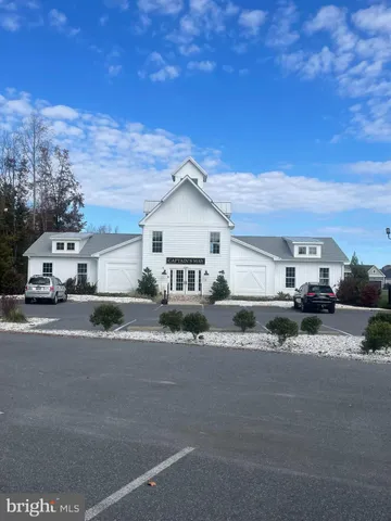a white house with a large tree in front of it
