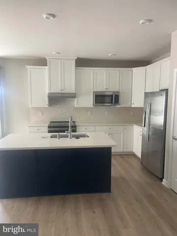 a kitchen with wooden cabinets and stainless steel appliances