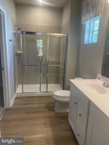 a bathroom with a toilet sink and shower