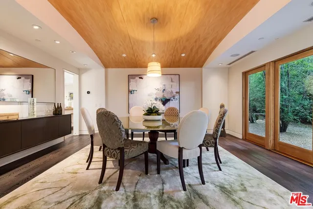 a dining room with furniture and wooden floor