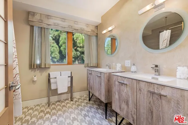 a spacious bedroom with a bed and wooden floor