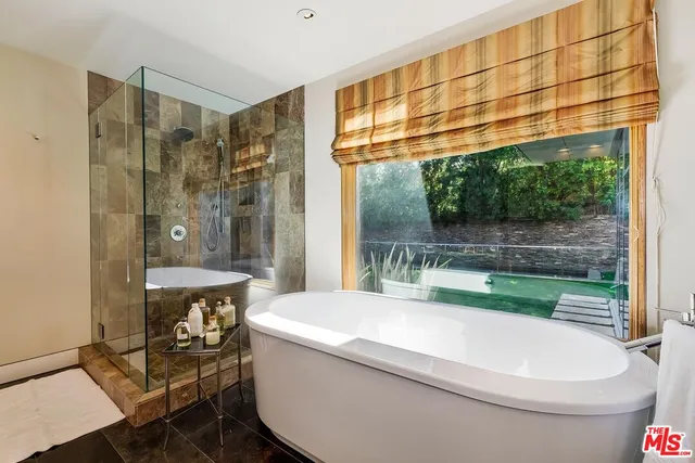 a backyard of a house with barbeque oven table and chairs