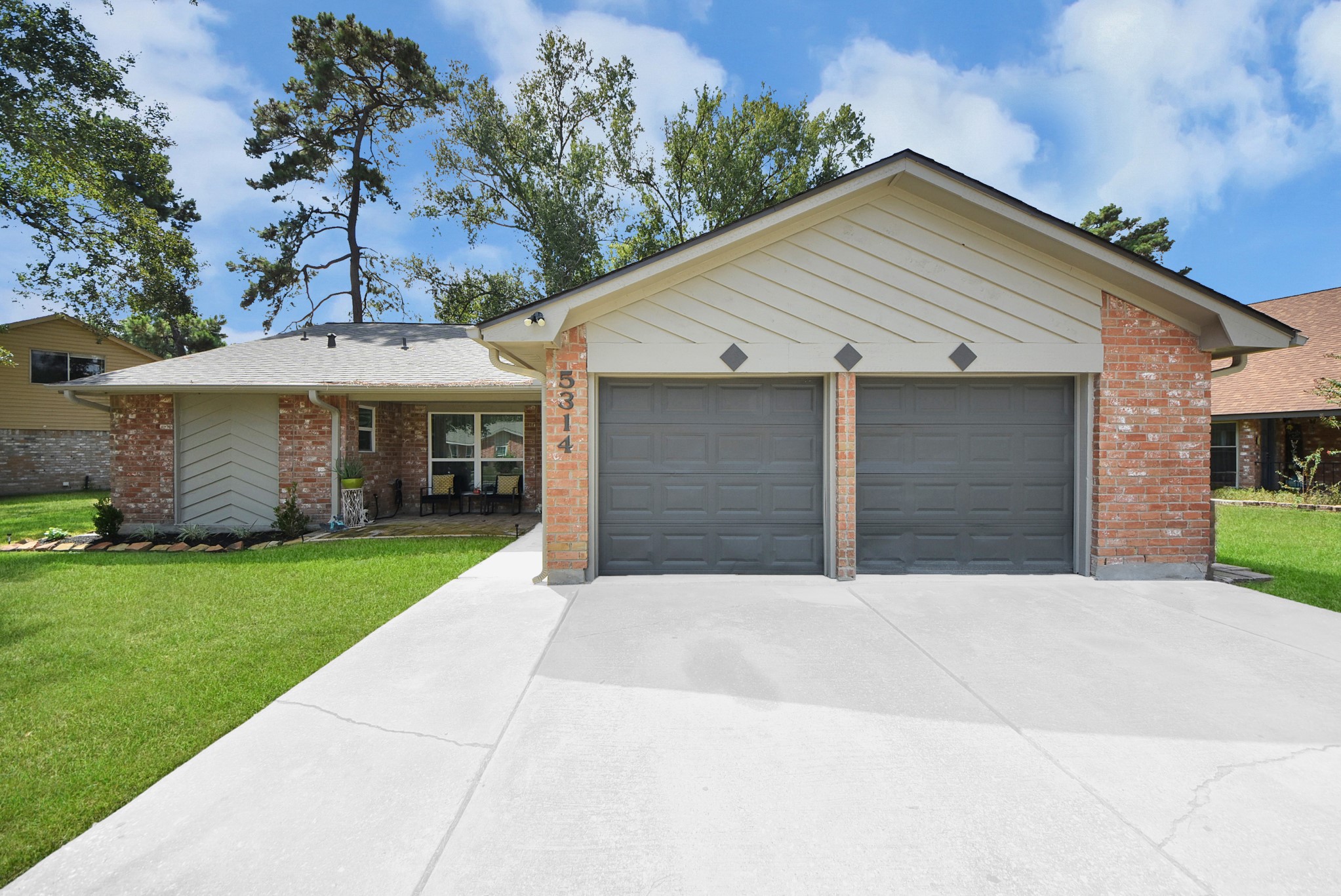 5314 Sweetwind Lane Spring, TX 77373 - Photo 3 of 47 Spacious two-car garage and well-maintained front yard, nestled in a serene neighborhood.