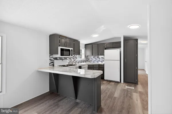 a kitchen with stainless steel appliances a sink stove and refrigerator