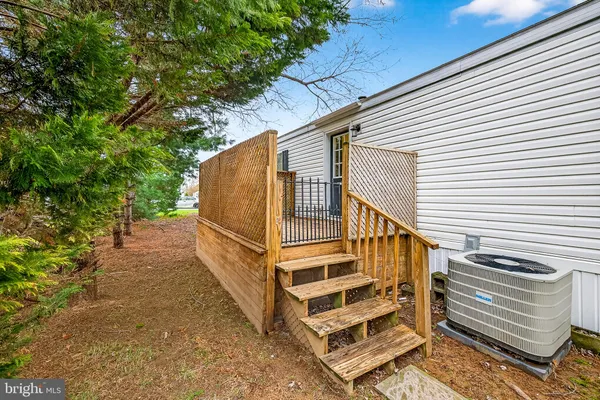a view of backyard with deck and garden