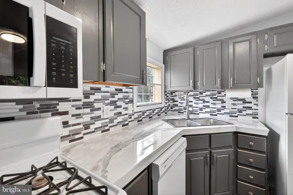 a kitchen with a sink and a stove top oven