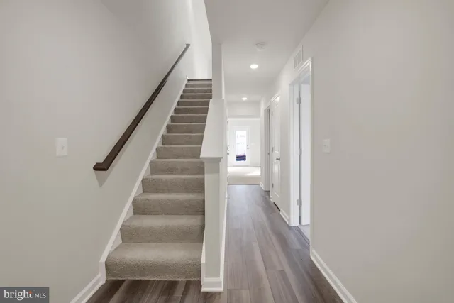 a view of entryway and gallery with wooden floor
