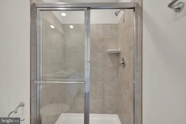 a bathroom with a glass shower door