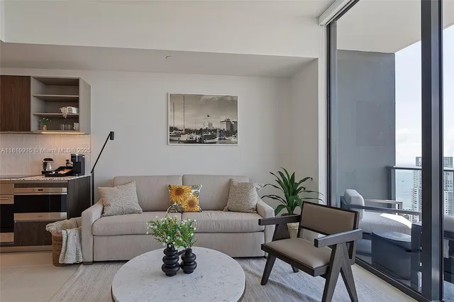 a living room with furniture and a potted plant