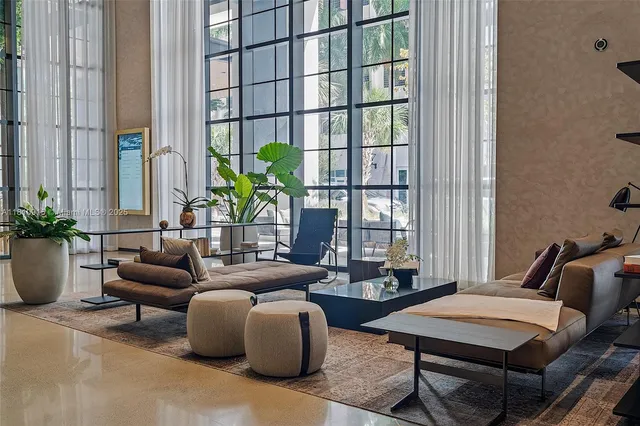 a living room with furniture and a potted plant