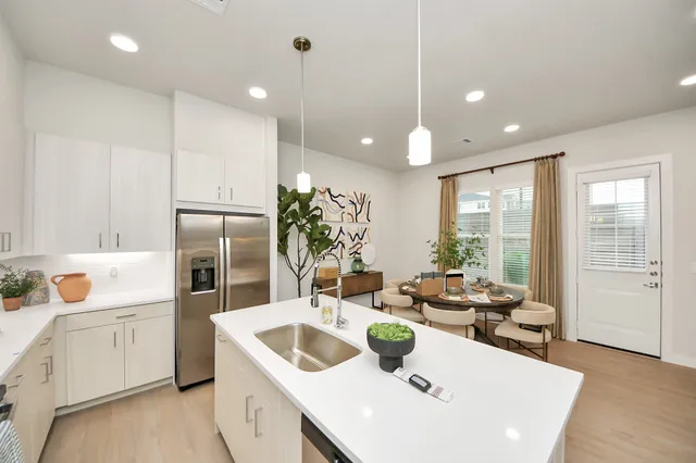 a large kitchen with a table and chairs