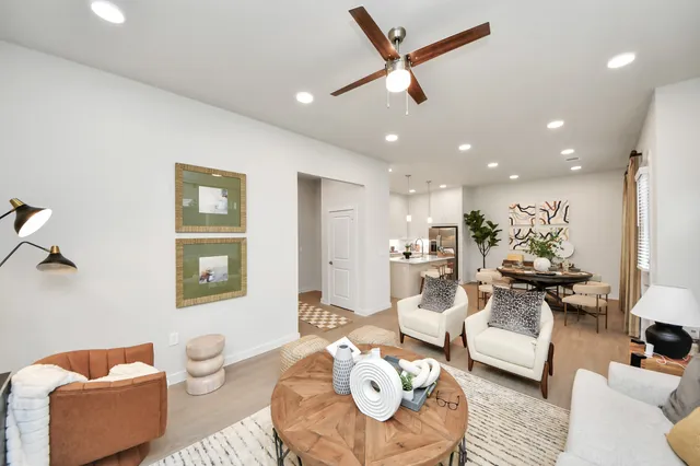 a picture of a living room with furniture and wooden floor