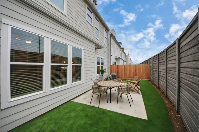 a view of a house with backyard and a sitting area