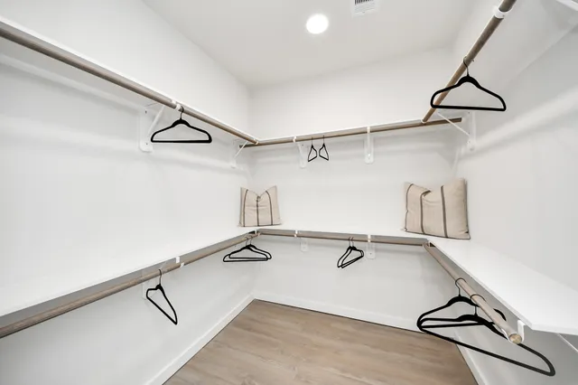 a bedroom with furniture and a chandelier fan