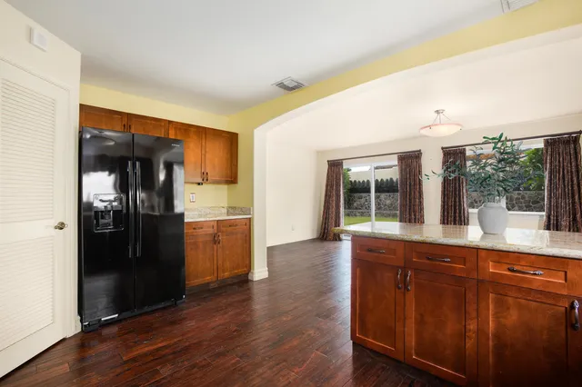 a kitchen with stainless steel appliances granite countertop a refrigerator and a sink