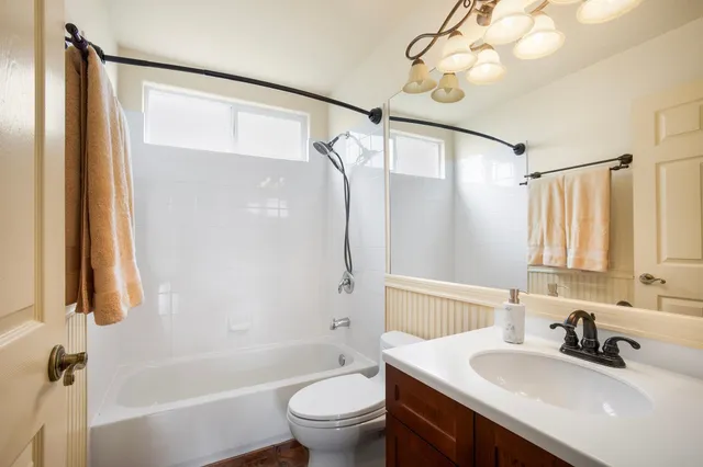 a bathroom with a sink a toilet and a mirror