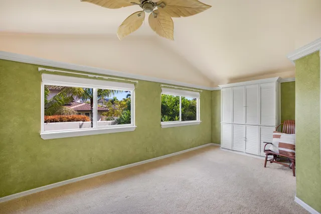 a view of a room with window and a ceiling fan