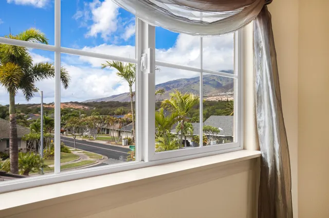 an empty room with cabinet and mirrors