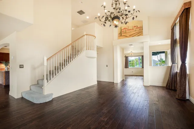 a view of a livingroom with wooden floor and stairs