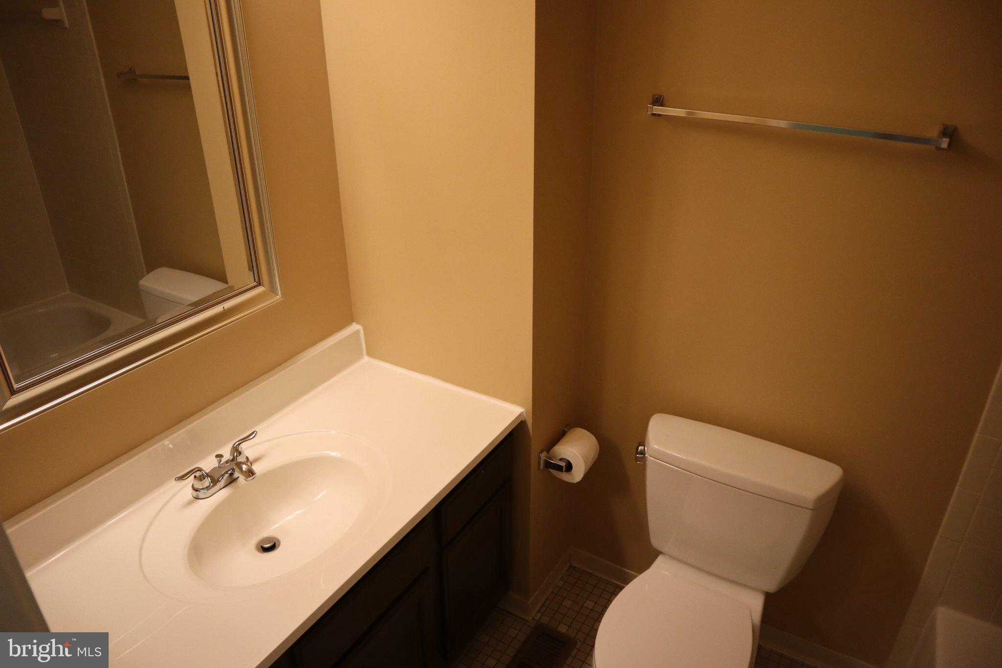 10848 Douglas Avenue Silver Spring, MD 20902 - Photo 20 of 33 a bathroom with a sink and mirror with toilet