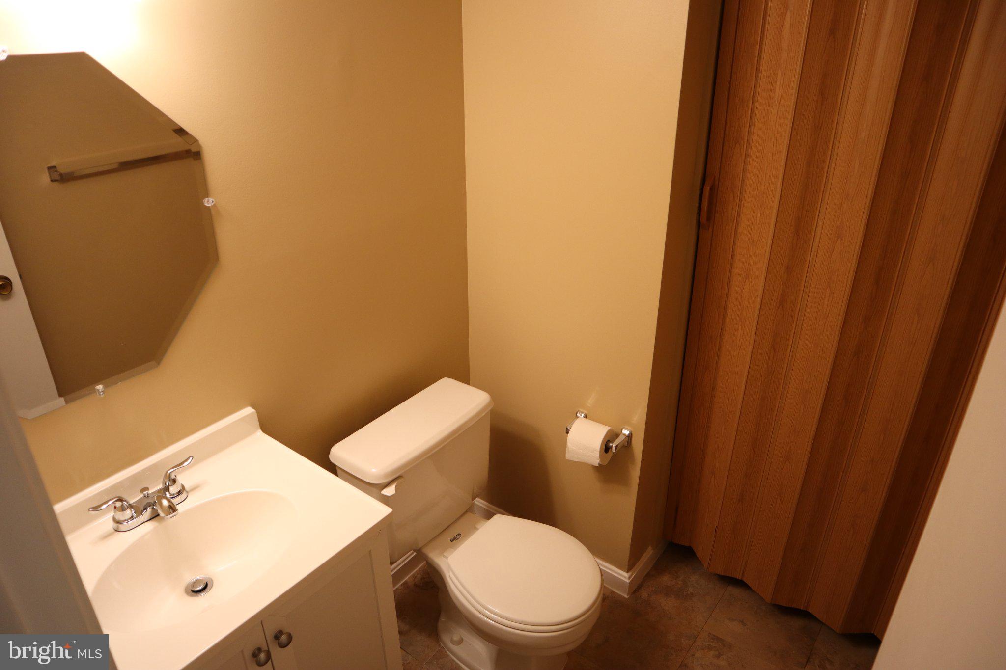 10848 Douglas Avenue Silver Spring, MD 20902 - Photo 29 of 33 a white toilet sitting next to a small sink